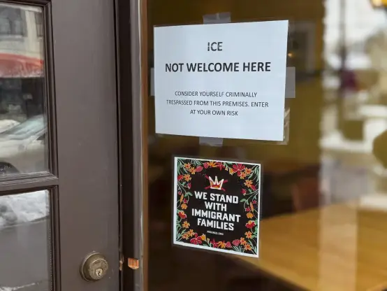 Signs posted on the front door of Turtle Bread express opposition to ICE and support for immigrant families on Tuesday in Minneapolis.