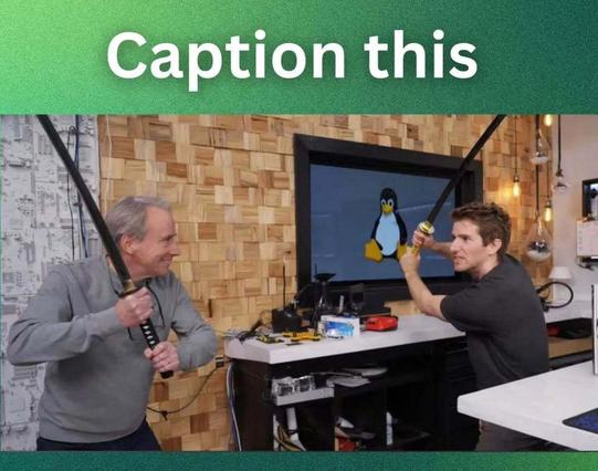 Caption this

Below that title is a photo of Linus Torvalds (on the left) and Linus Sebastian (on the right) wielding black-colored katana in their hands in a fighting position, facing each other.