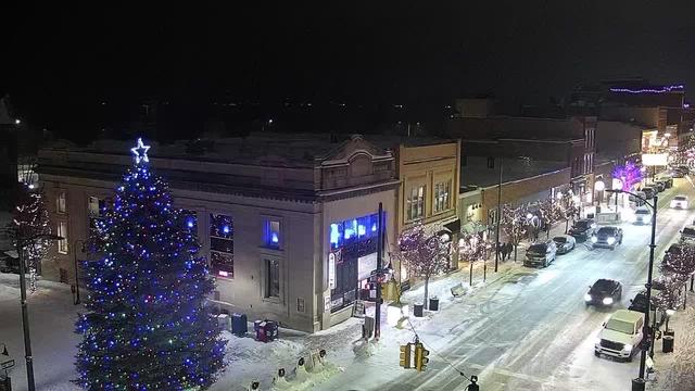 NE view from the intersection of Cass St and Front St in Traverse City with Traverse Bay and Lake Michigan beyond. // Image captured at: 2025-12-13 01:06:05 UTC (about 1 min. prior to this post) // Current Temp in Traverse City: 26.14 F | -3.26 C // Precip: light snow // Wind: SW at 9.999 mph | 16.09 kph // Humidity: 75%