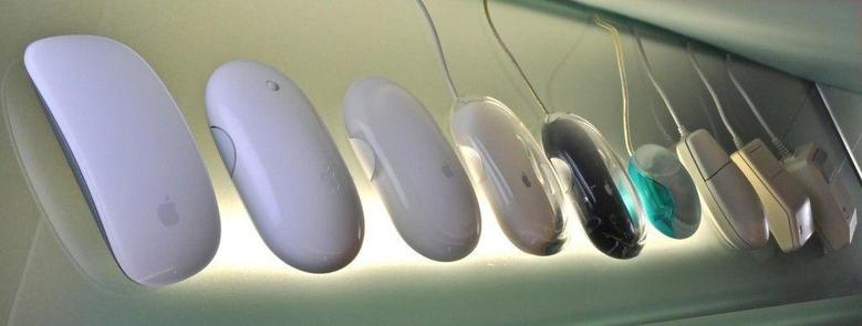 Conferences That Work continually evolve. Rather like how the design of Apple mice has changed over the years. Photograph of the first nine versions of the Apple Mouse displayed on a plexiglass board. Photo attribution: Flickr user raneko