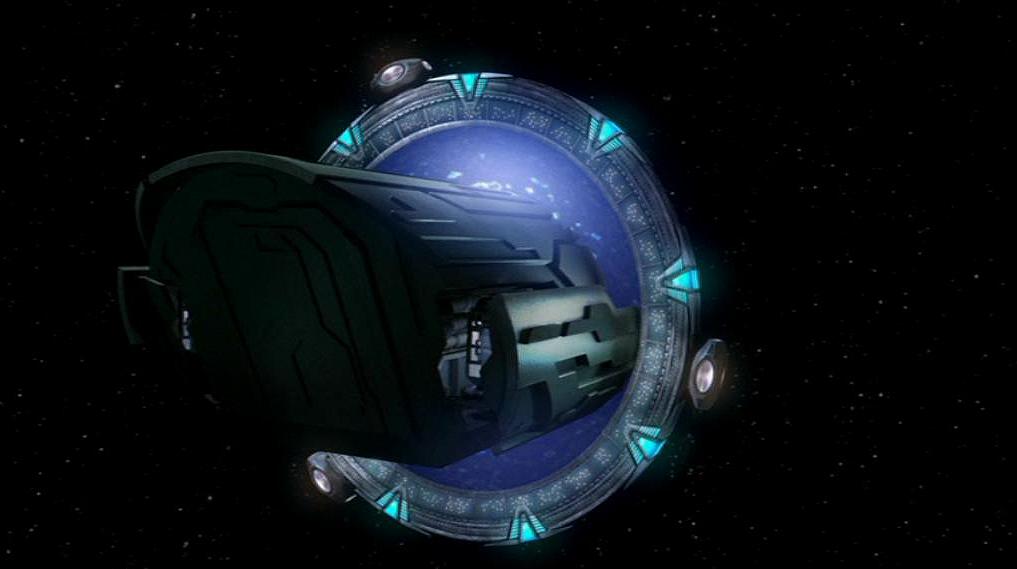 A puddle jumper spaceship is halfway through the Stargate in deep space