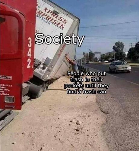 A humorous image showing a large tractor-trailer truck tipped over onto its side on the shoulder of a highway, with the trailer leaning heavily to the right. A person is struggling to push back against the massive, tipping trailer with their hands. Overlaid text labels the truck as "Society" and the person pushing as "People who put trash in their pockets until they find a trash can."