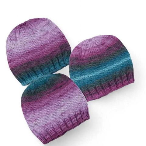 Three knitted beanies lie on a plain white background. Each hat features the same gradient pattern blending purples, pinks, greys, and teal, arranged in slightly different orientations.