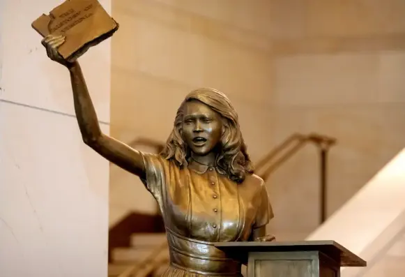 a statue of Barbara Rose Johns holding aloft a history book