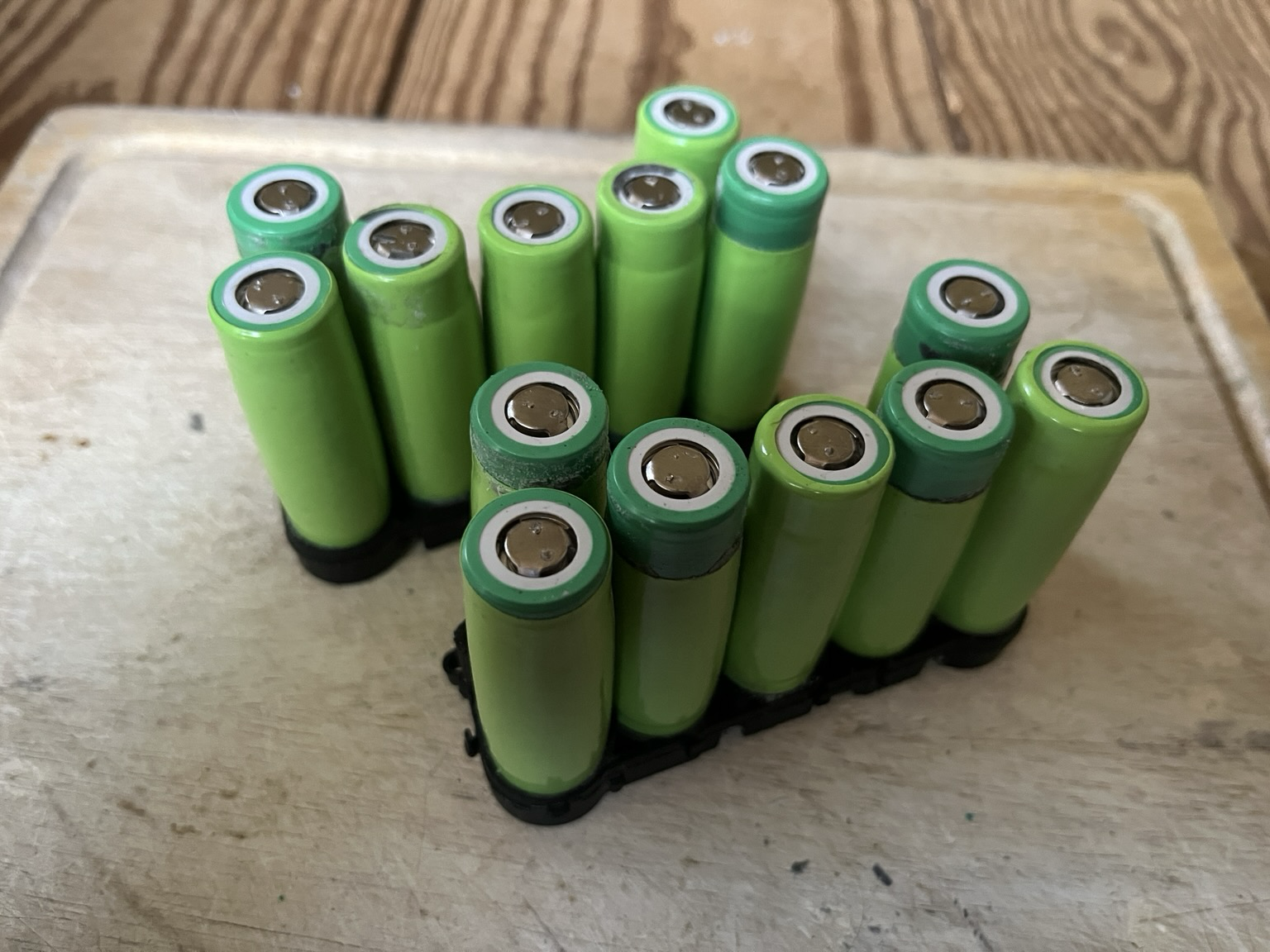 Lithium ion cells removed from nickel strips standing in base of cell holders