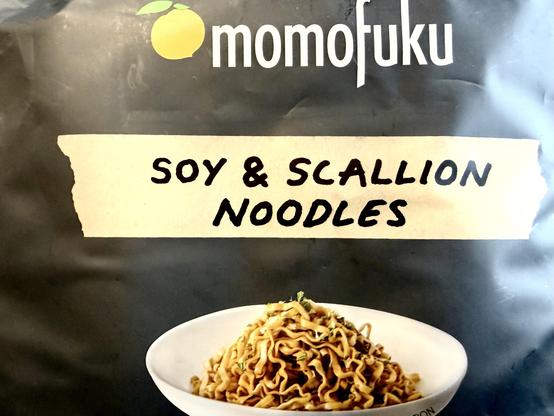 Photo of the front of the packaging for Momofuku noodles, “Soy and Scallion” flavour.