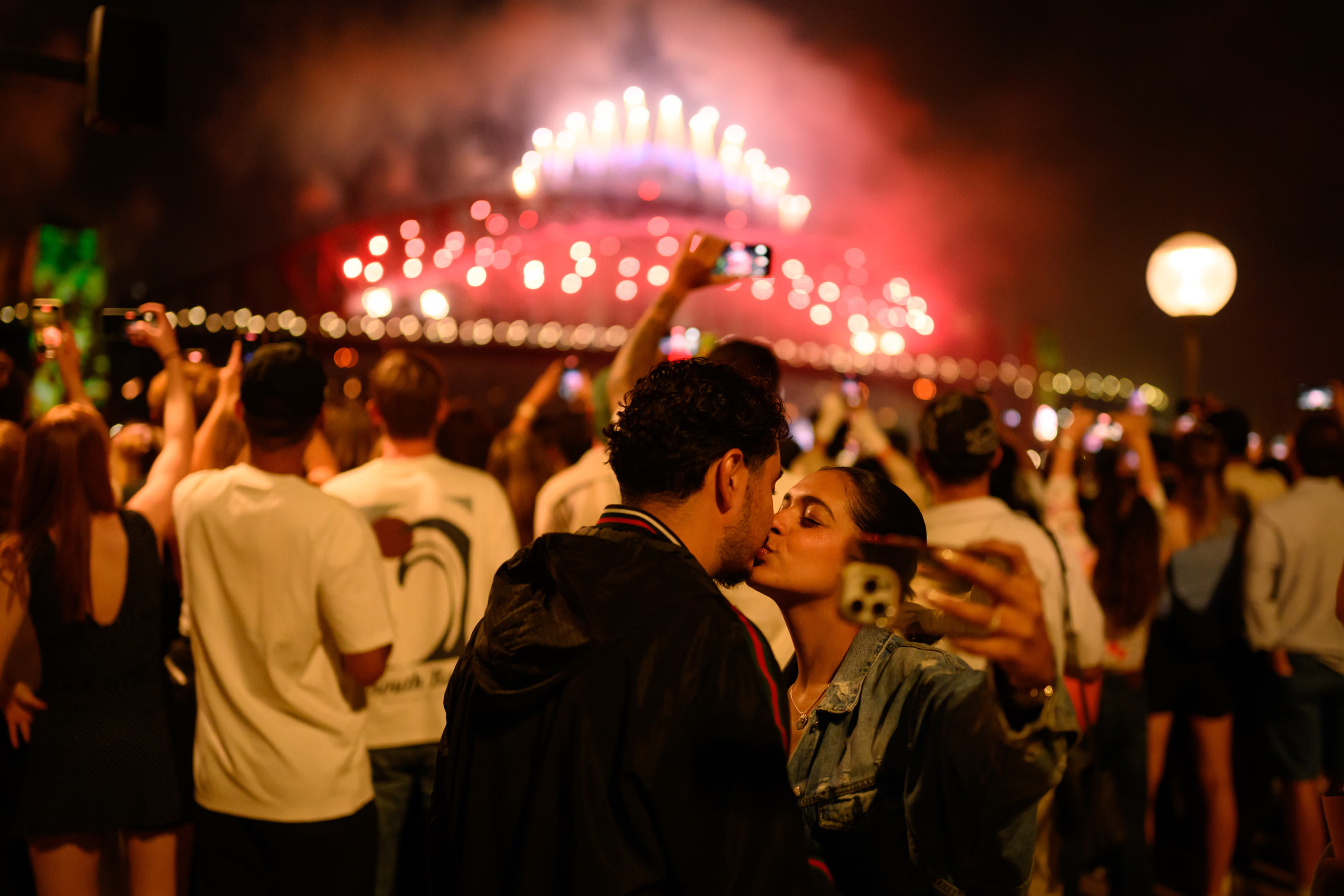 A couple share a kiss at the Sydney display.