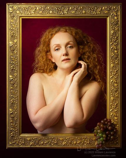 Model Ivory Flame poses nude in a gold frame, engaging the camera, and with her arms covering her chest.