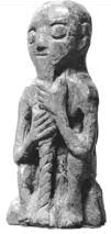 Whalebone figure of a man clutching his beard, interpreted to be Thor.