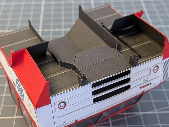 A detailed view of the bottom of the cab, including joints for attaching it to the chassis and a pipe.