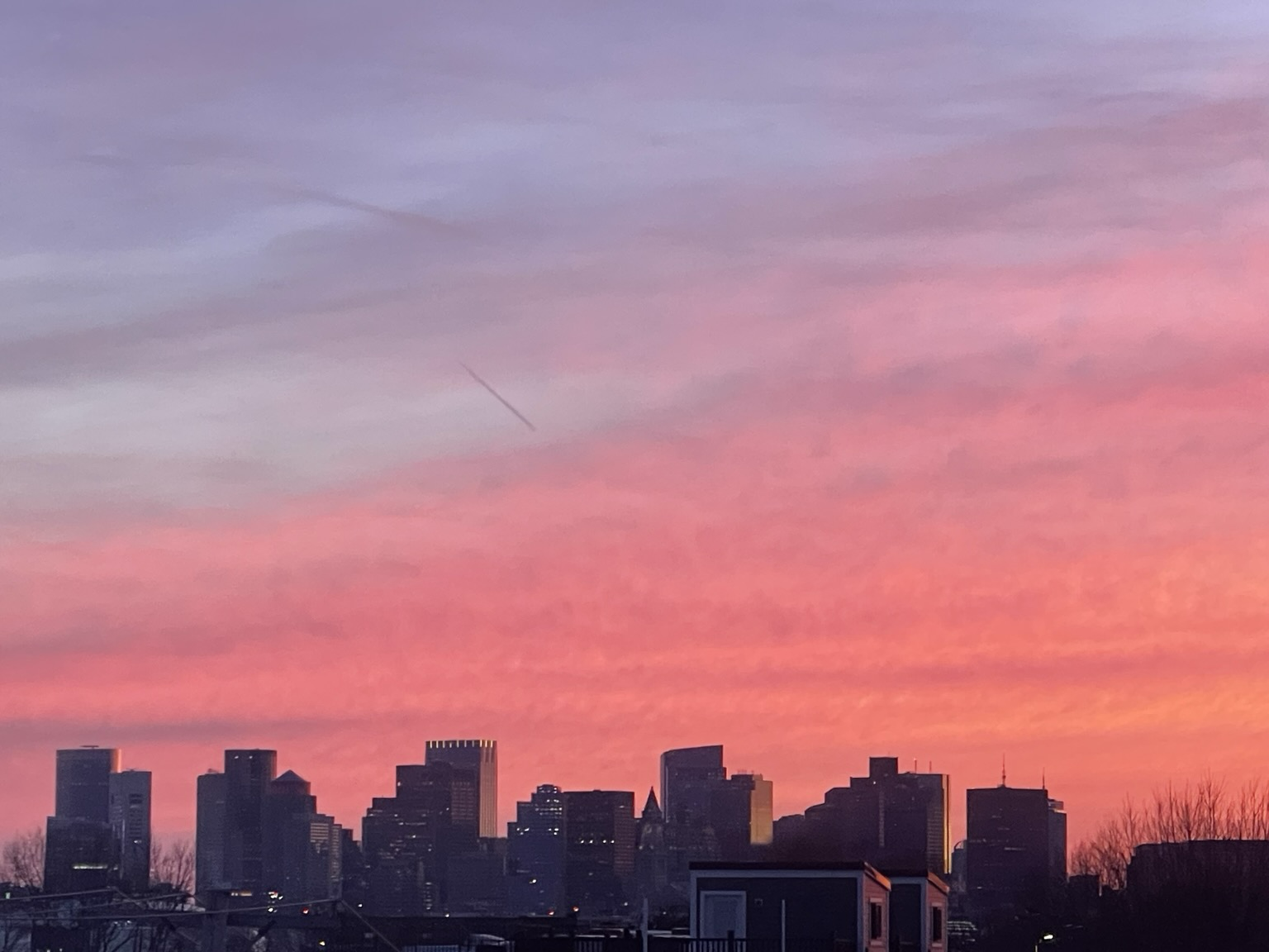The sunset over the Boston skyline was pink purple, and some still blue sky