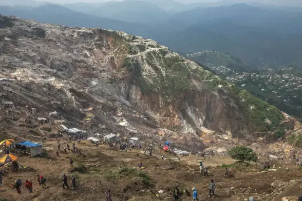 The site of a landslide at a coltan mine in DRC.

The workers get $1 for 14 hours work a day.