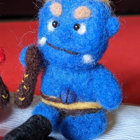 Tiny felt red and blue oni with lucky beans and makizushi.