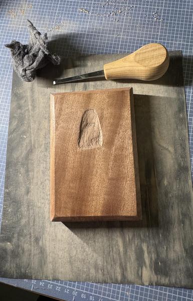 Wooden board with a groove carved into it.