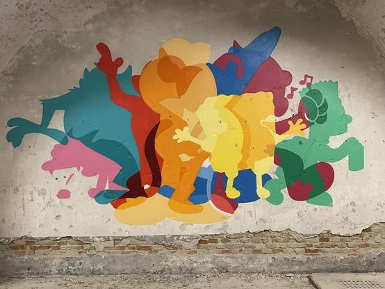 wall painting depicting many comic figures in various colors