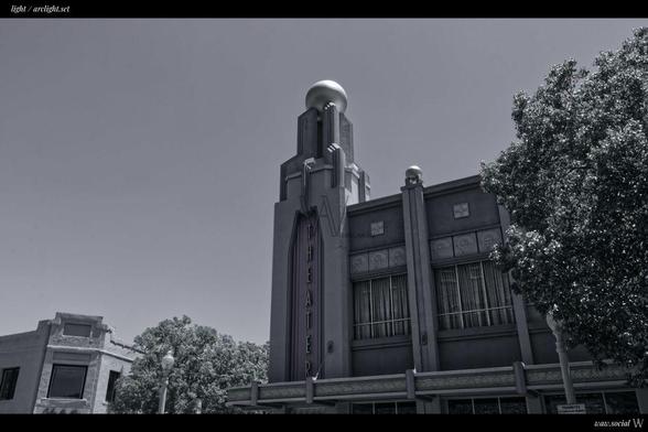 A black and white photography of a former ArcLight theatre in Culver City, California with trees in the fore and background.