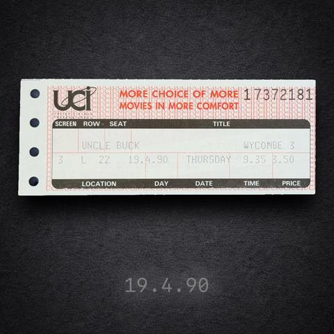 Square image of a vintage UCI cinema ticket on a dark, textured background. The ticket shows the UCI logo and the slogan “More choice of more movies in more comfort.” The film title reads “UNCLE BUCK” and the location is listed as Wycombe 3. Screen 3, Row L, Seat 22. Day: Thursday. Date: 19.4.90. Time: 9.35. Price: £3.50. Four punched holes run down the left edge. The date “19.4.90” is overlaid at the bottom of the image.