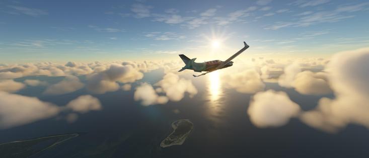 A small propeller-driven aircraft with a black fuselage and red stripes flies above a thick layer of soft white clouds. The sun shines directly behind the plane, creating a bright glare and a shimmering reflection on the dark blue ocean below. The aircraft’s nose is tilted slightly upward, suggesting a steady climb or level flight. Beneath the clouds, the ocean appears calm and expansive, with a small, tree-covered island visible near the center. The sky transitions from a clear, vibrant blue at the top to a golden-orange near the horizon where the sun is positioned. This scene captures a serene moment in flight, with the aircraft navigating through the cloud layer above the sea, illuminated by the sun's rays and surrounded by the vastness of the sky and ocean.