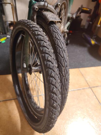 Přední kolo Bromptonu s holým pláštěm Schwalbe Winter vedle