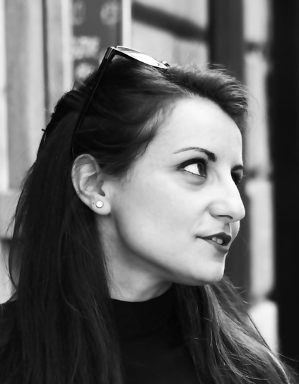 A black and white photo of Simona wearing sunglasses and a dark jumper.
