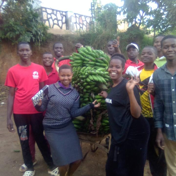 The entire team of Fill the Empty Stomachs Farming Initiative after harvesting bunches of bananas to feed our community.