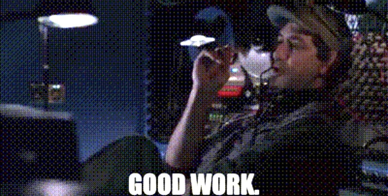 Whistler from the movie Sneakers leaning back in his chair. The caption reads “Good work”.