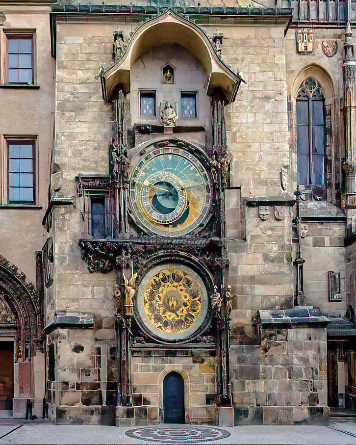 Das Bild zeigt die Prager Astronomische Uhr, die an der steinernen Fassade des Prager Altstädter Rathauses angebracht ist. Die Uhr verfügt über zwei große, runde Zifferblätter: Das obere Zifferblatt hat eine blaue und goldene Oberfläche mit dem lateinischen Text "HOROLOGIUM" über dem zentralen Bereich, und das untere Zifferblatt zeigt ein gelb-schwarzes dekoratives Muster. Gotische architektonische Elemente, darunter spitzbogige Fenster, geschnitzte Steindetails und Statuen, die sich auf beiden Seiten der Zifferblätter befinden, umgeben die Uhr. Die Steinwand des Gebäudes, die aus verwitterten beigen und grauen Blöcken besteht, enthält kleine rechteckige Fenster oberhalb der Uhr und eine dunkelblaue Tür unterhalb des unteren Zifferblatts. Zusätzliche dekorative Schnitzereien und Verwitterungsspuren sind an den angrenzenden Gebäudeteilen sichtbar.
Bereitgestellt von @altbot, privat und lokal generiert mit Qwen3-Vl:8b