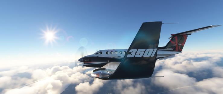 A private jet is in flight, its dark winglet prominently marked with “350i” in large white letters. The aircraft’s fuselage combines white and dark gray, featuring a row of small circular windows along the side, with a propeller visible on the left wing. The jet glides above a dense layer of fluffy white clouds, with glimpses of the earth’s surface below—including land and water formations—visible through gaps in the cloud cover. The sky is a clear, vibrant blue, with the sun shining brightly in the upper left corner, producing distinct lens flares that enhance the scene’s brightness. The plane moves smoothly, its polished exterior catching sunlight, while the tail displays a red stylized logo adding a distinctive visual element. The context of the scene shows calm, sunny high-altitude travel, with the jet cutting through the atmosphere against a backdrop of serene sky and cloud layers. Below, the earth’s surface is partially visible, suggesting a mix of terrain and possibly water bodies. The overall impression is one of stable motion under a bright, cloudless sky.