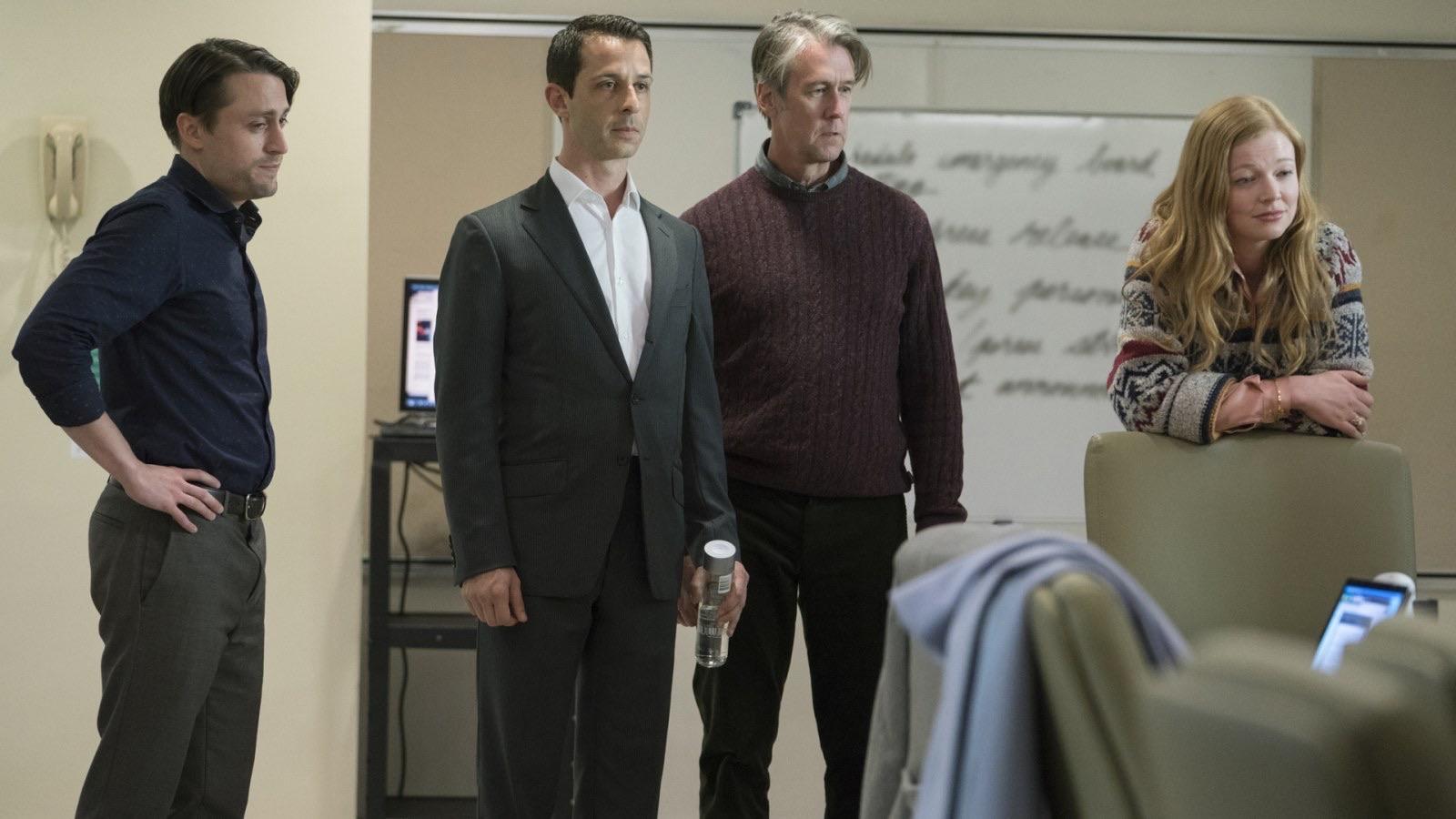 Photo of Roman, Kendall, Connor, Shiv standing in a room.