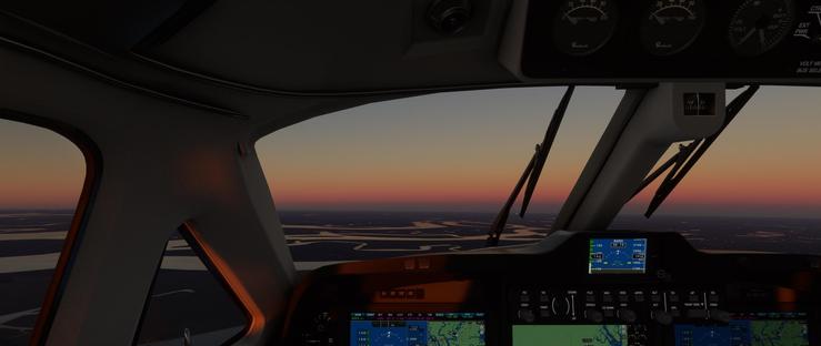 Aircraft cockpit interior with a darkened cabin, featuring an array of illuminated instruments and digital displays. The windshield reveals a panoramic view of a landscape under a dusky sky, where the horizon transitions from warm orange to deep pink to muted blue. The cockpit’s primary controls include a central panel with multiple screens showing navigational data and system status. Visible text on the displays includes "BARO", "ALT", "VOLT", "EXT PWR", "D-MJXY", and numerical values such as "318-19", "2180", "1600", "1780", "2125". The windshield wipers are stationary, and the exterior terrain features a network of winding roads or rivers beneath the fading daylight. The overall scene captures a moment of calm during sunset, with the cockpit’s interior lighting casting a soft glow on the instrument panel and surrounding components. The cockpit remains stationary, offering a serene view of the earth below as the sky darkens.