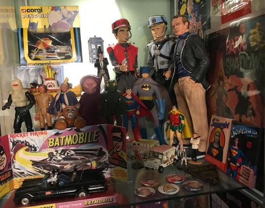 Display cabinet filled with old toys and memorabilia.