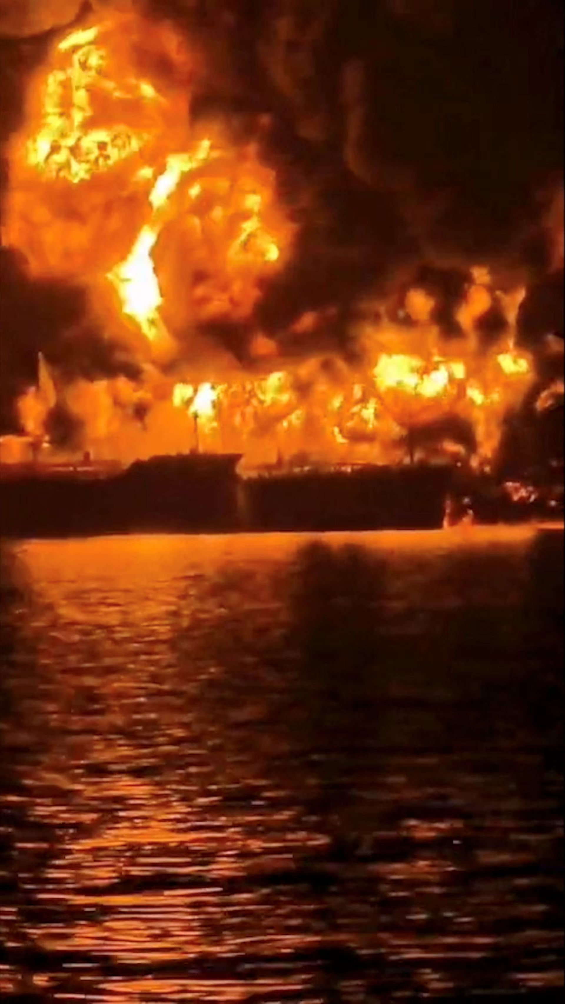 A ship burns, after Iranian explosive-laden boats appear to have attacked two fuel tankers in Iraqi waters setting them ablaze.