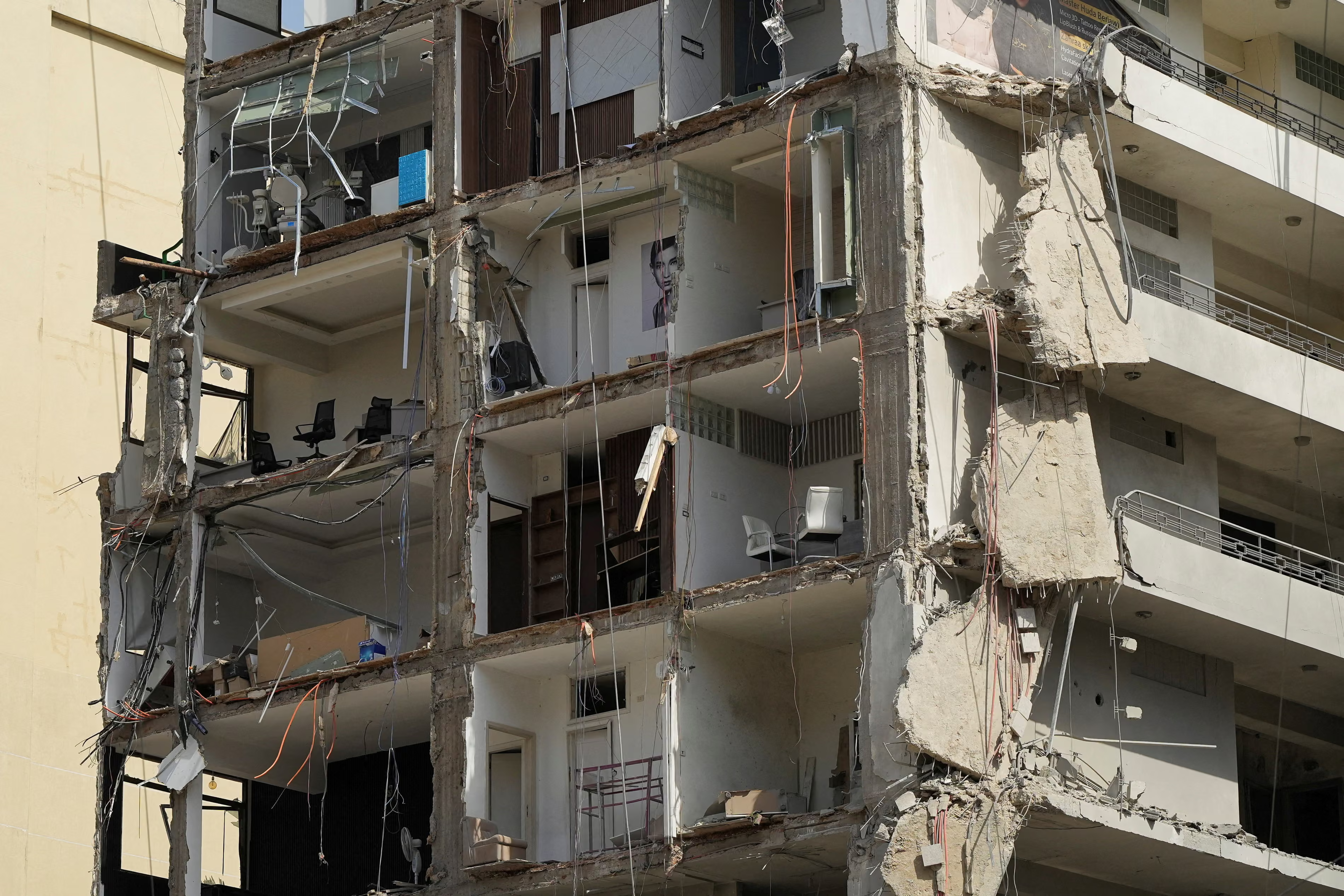 A building in the capitalโs southern suburbs that was destroyed by Israeli strikes, with furniture & portraits on the walls showing.