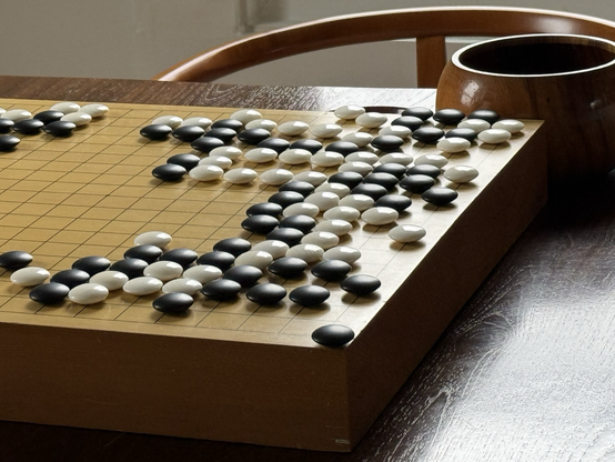 A picture of a game of Go on a table