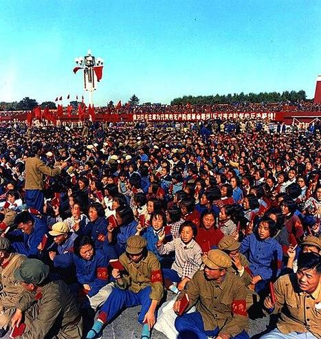 Picture shows thousands of Red Guards in Tianeman Square during the cultural revolution. A mixture of people in unform and civilians seated. Banners round the square have red Chinese writing