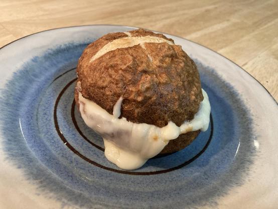A sandwich consisting of a pretzel bun with mozzarella cheese.