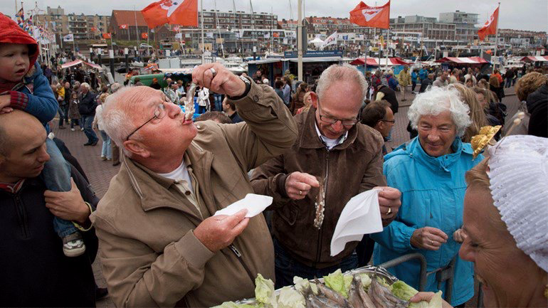 Elderly Dutch people slide herring down their throats in full view of the shopping public, like shameless pelicans.
