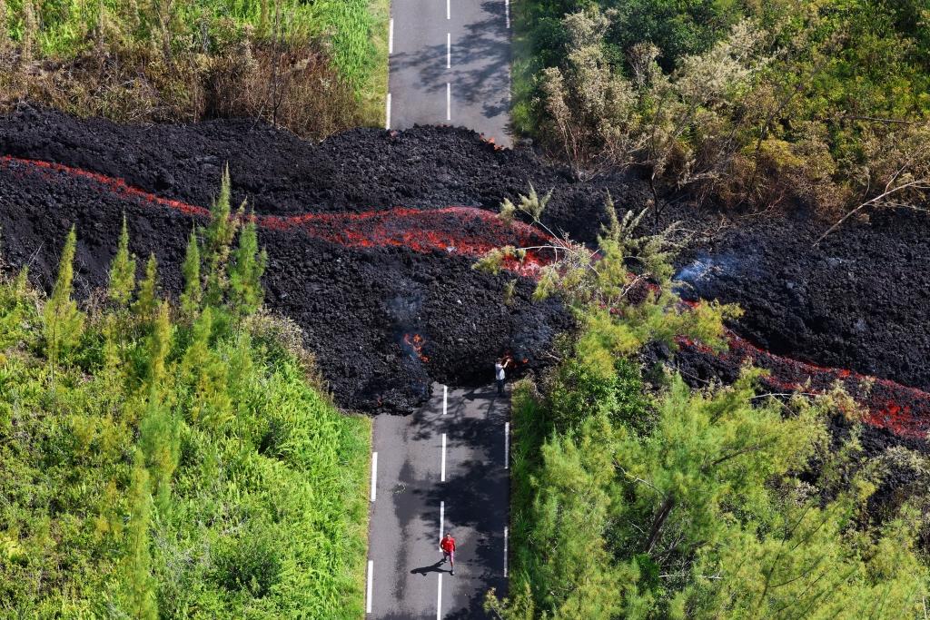 Lava flows across a road.