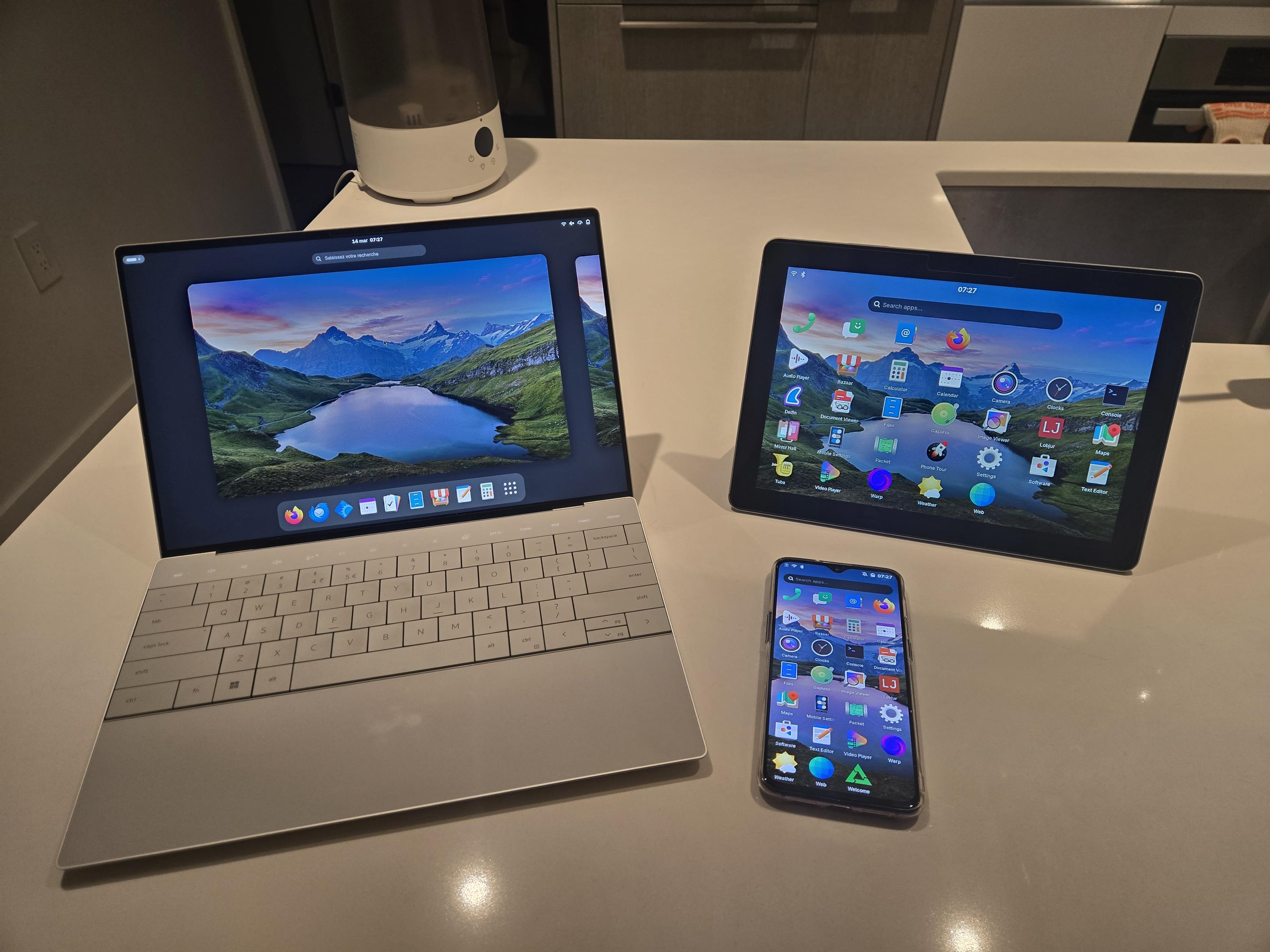 A laptop, tablet and phone running the stack described in the post