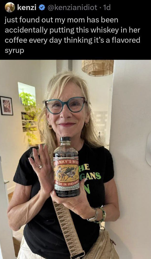 A woman smiling with smug expression holds a bottle of "Shanky’s Whip" Irish Whiskey. Ccaption text above her explains that she had been accidentally adding the whiskey to her coffee every day, thinking it was a flavored syrup.