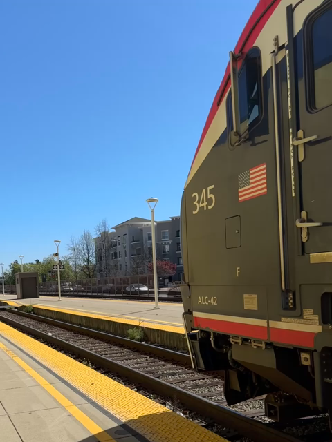 The southbound Amtrak Coast starlight train 11 coming into Oakland Jack London Square station.