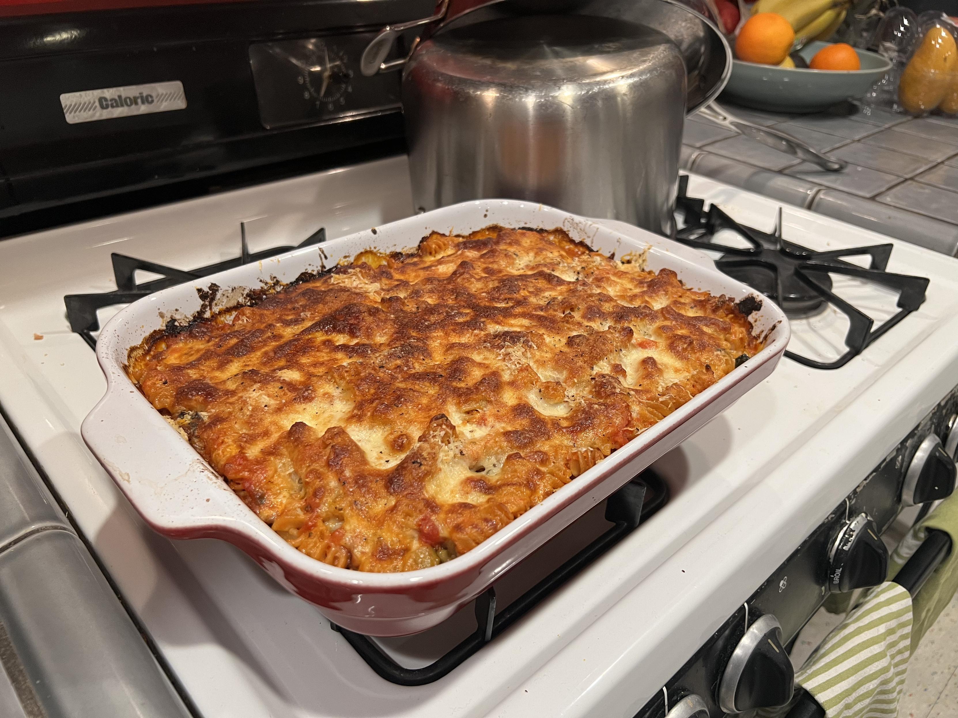 Baked ziti fresh out of the oven, the baked cheesy crust is looking very scrumptious