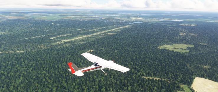 A small, single-engine propeller airplane with a white body and red accents on the tail and rear fuselage flies low over a densely forested landscape. The aircraft is angled slightly upward, suggesting it is either climbing or maintaining steady flight. The registration D-MJXY is visible on the side of the fuselage.
Below the plane, a vast expanse of green forest stretches out, broken occasionally by clearings, fields, and patches of farmland. A long, straight runway from a former airport is visible through the forest, running parallel to the planes flight path. The horizon reveals a mix of flat terrain and distant fields, with the sky above mostly clear, dotted with scattered clouds. The scene conveys a sense of open space and natural landscape, with the airplane as the only visible sign of human activity.