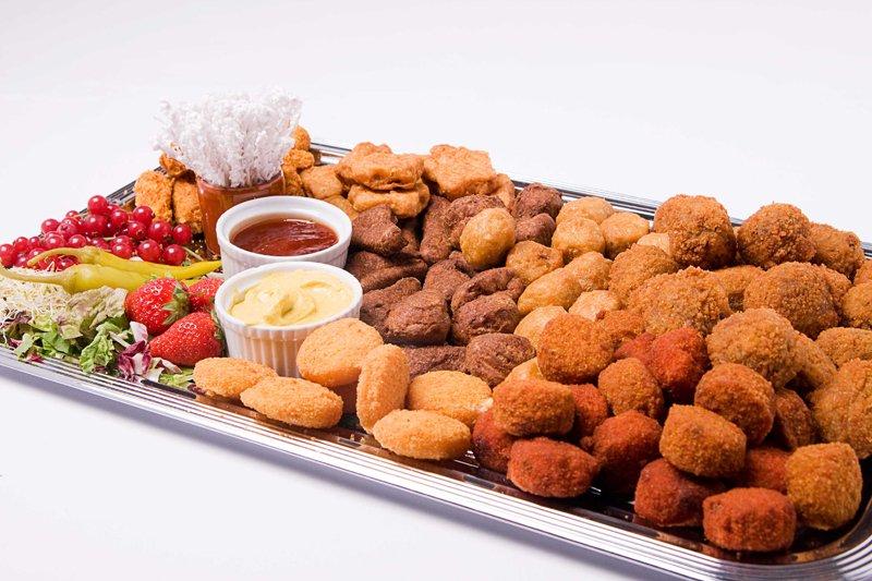 A selection of nondescript, deep-fried snacks lie waiting to be dipped into two tiny bowls of sauce, which will only be enough for approximately seven of the 48 snacks on display.