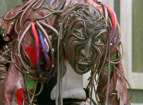 Close up of a "wheeler". A frightening mask with a body made up of a bunch of small tubes or wires.