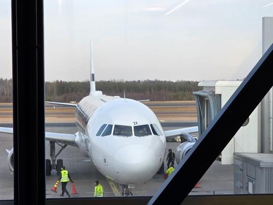 The front of a Finnair aeroplane seen from he terminal. 