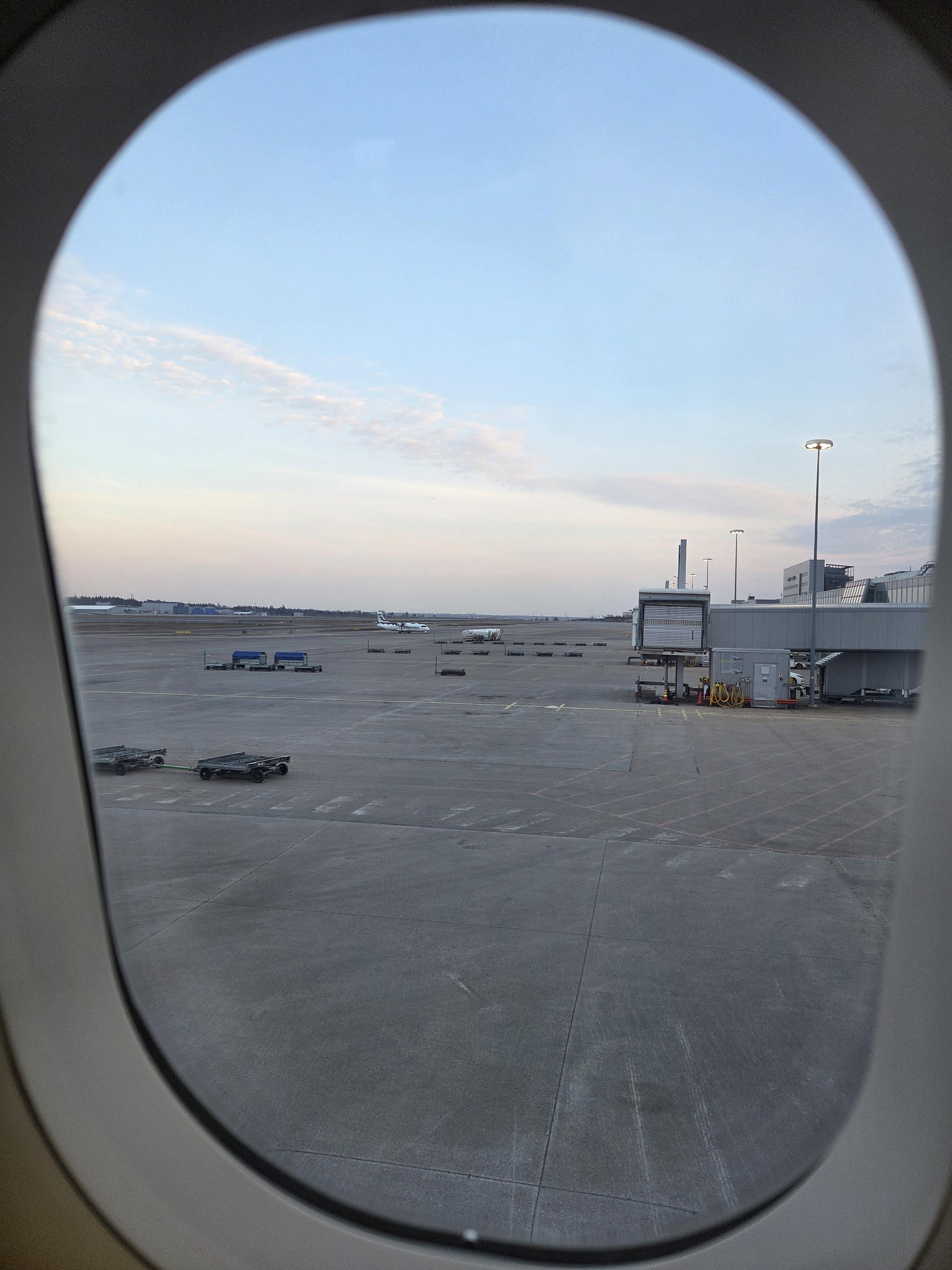 View out of the plane window of mostly blue sky.
