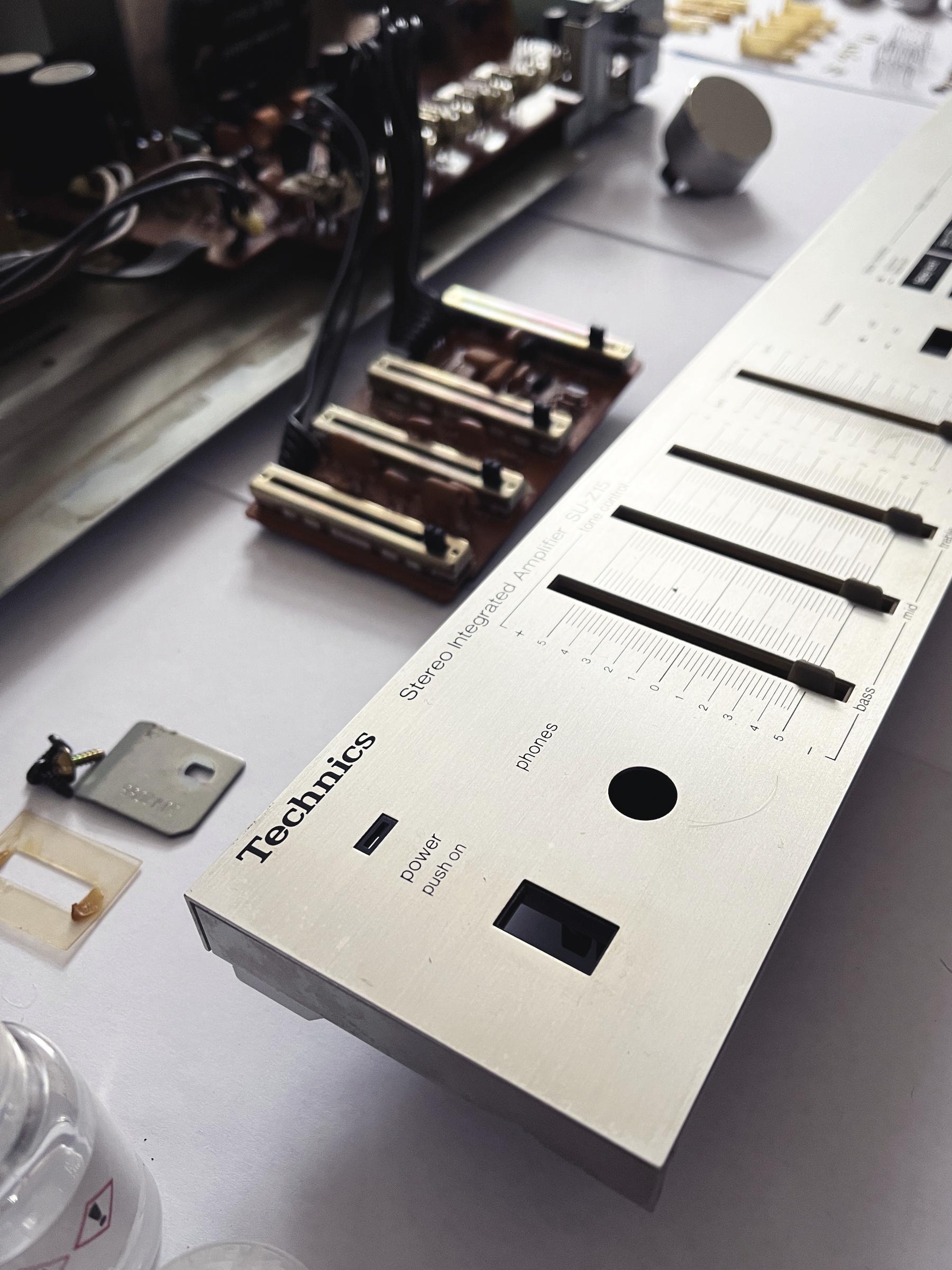 Close-up of the Technics amp chrome fascia, disconnected from the main unit, ready to be cleaned.