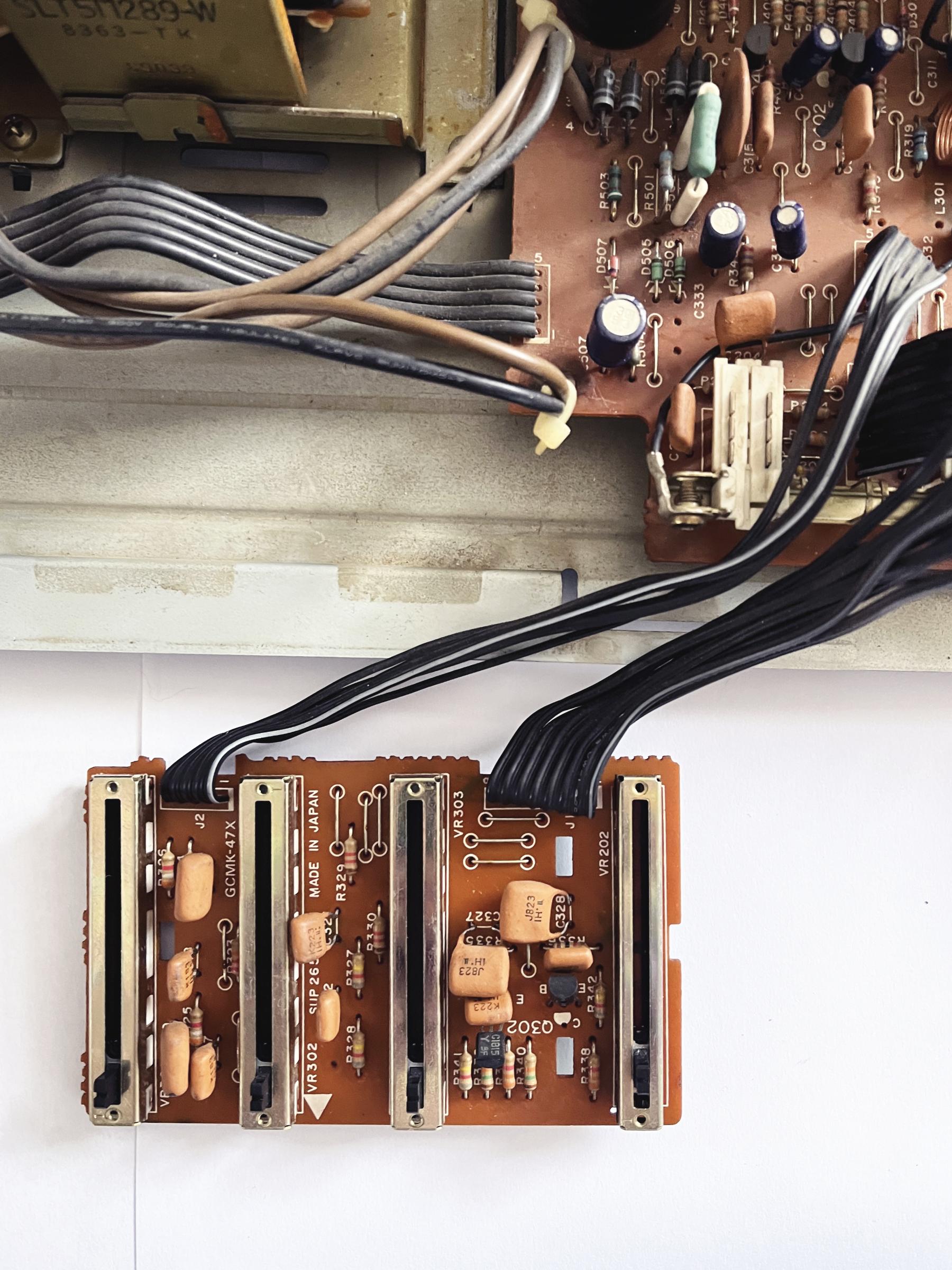 Close-up of the equaliser and balance faders board, with cables running to the main unit.