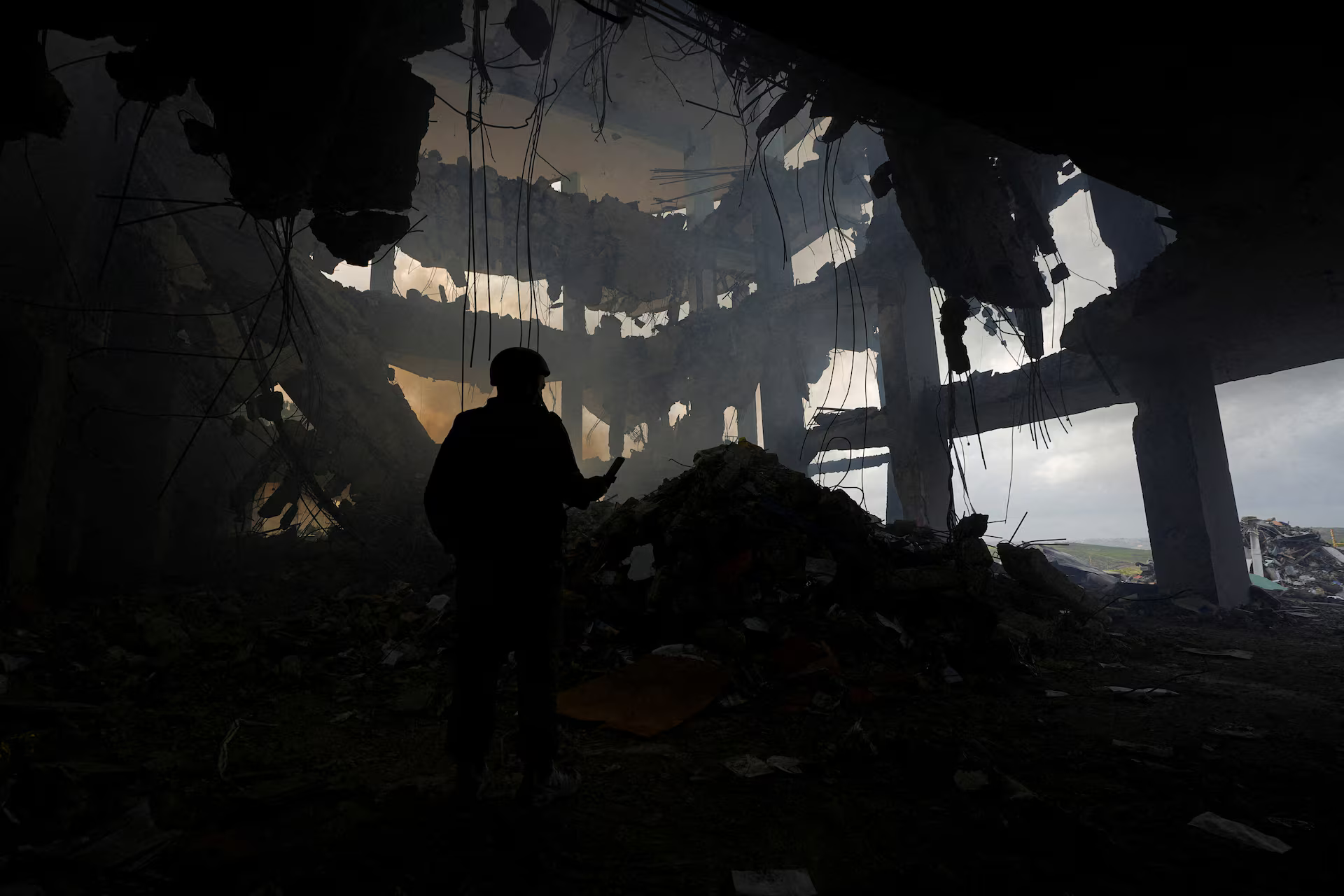 A person stands near rubble in the aftermath of an Israeli strike on a healthcare center.